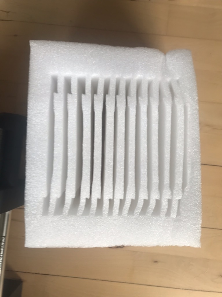 weight plates wrapped in thick white bubble wrap